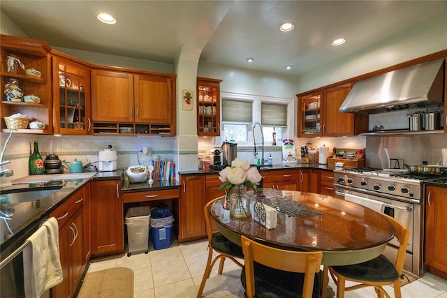 42-32 204th St, Bayside, NY 11361 - kitchen with wall chimney range hood, stainless steel appliances, a sink, light tile patterned floors, and brown cabinets