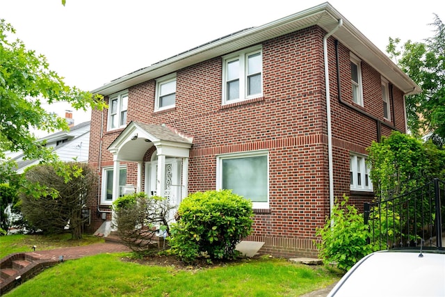 42-32 204th St, Bayside, NY 11361 - traditional home with brick siding and a front lawn