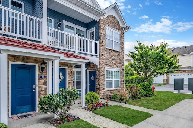 135 Rosebud Ct Unit 135, Patchogue, NY 11772 - view of front of property featuring stone siding and a balcony