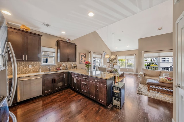 135 Rosebud Ct Unit 135, Patchogue, NY 11772 - kitchen with appliances with stainless steel finishes, a sink, dark wood-style floors, a peninsula, and dark brown cabinetry