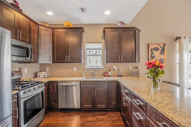 135 Rosebud Ct Unit 135, Patchogue, NY 11772 - kitchen with stainless steel appliances, a sink, light stone countertops, dark wood-type flooring, and recessed lighting