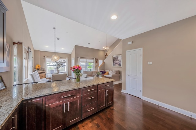 135 Rosebud Ct Unit 135, Patchogue, NY 11772 - kitchen with open floor plan, dark wood-style floors, light stone counters, baseboards, and a peninsula