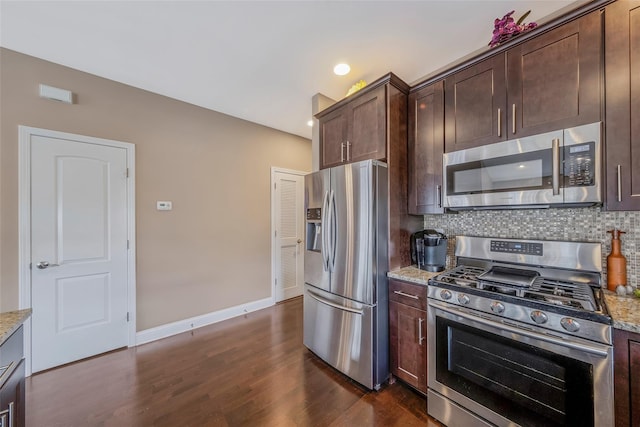 135 Rosebud Ct Unit 135, Patchogue, NY 11772 - kitchen with appliances with stainless steel finishes, backsplash, dark brown cabinetry, dark wood-style floors, and light stone counters