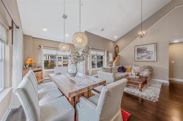 135 Rosebud Ct Unit 135, Patchogue, NY 11772 - dining area featuring a chandelier, high vaulted ceiling, wood finished floors, and baseboards