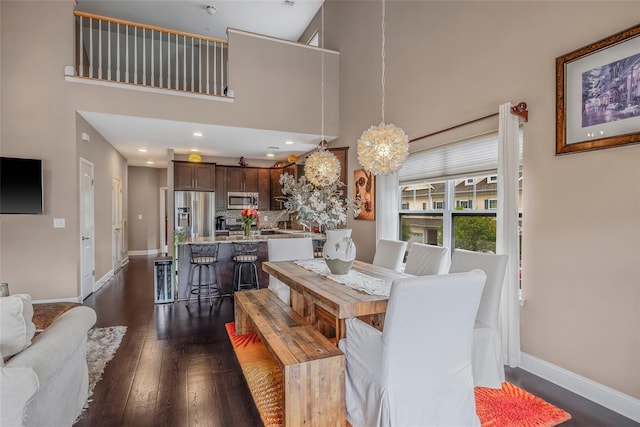 135 Rosebud Ct Unit 135, Patchogue, NY 11772 - dining area with dark wood finished floors, a high ceiling, baseboards, and recessed lighting