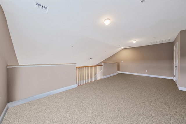 135 Rosebud Ct Unit 135, Patchogue, NY 11772 - additional living space with carpet, baseboards, and vaulted ceiling