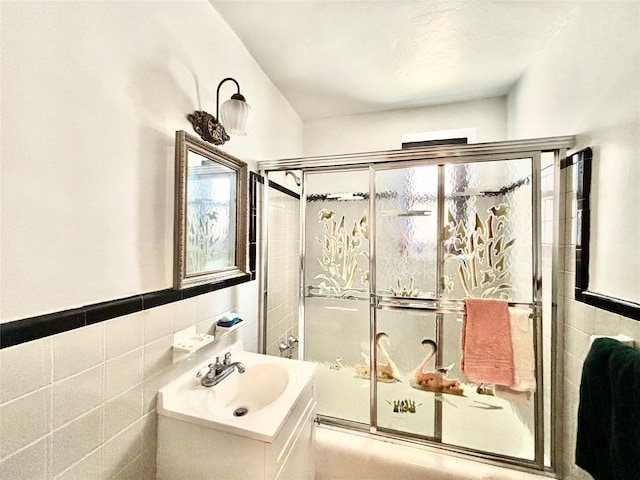 26-20 141st St Unit 1E, Flushing, NY 11354 - full bath featuring tile walls, vanity, a wainscoted wall, and enclosed tub / shower combo