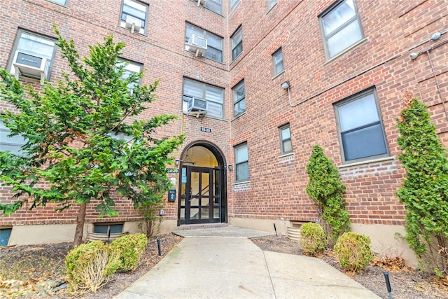 26-20 141st St Unit 1E, Flushing, NY 11354 - view of exterior entry with brick siding and cooling unit