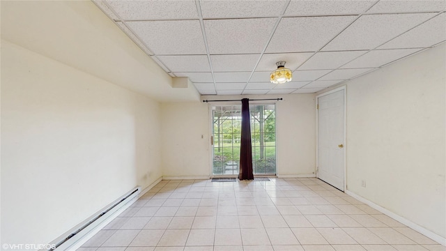 3 Caledonia Cir, Highland Mills, NY 10930 - spare room with a drop ceiling, a baseboard heating unit, baseboards, and light tile patterned floors