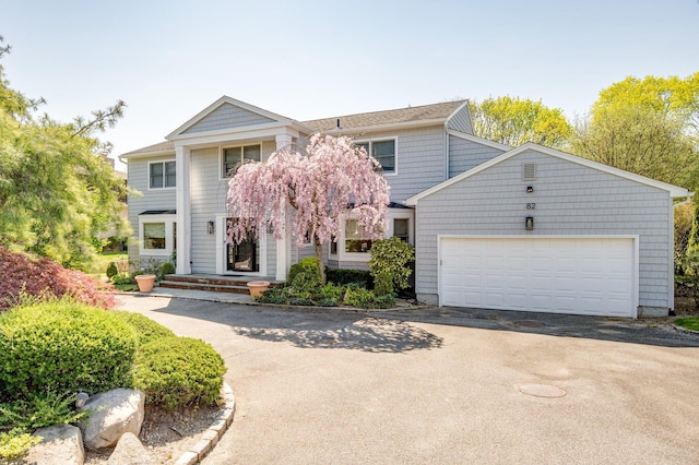 82 Woods Dr, East Hills, NY 11576 - view of front of house with driveway and a garage