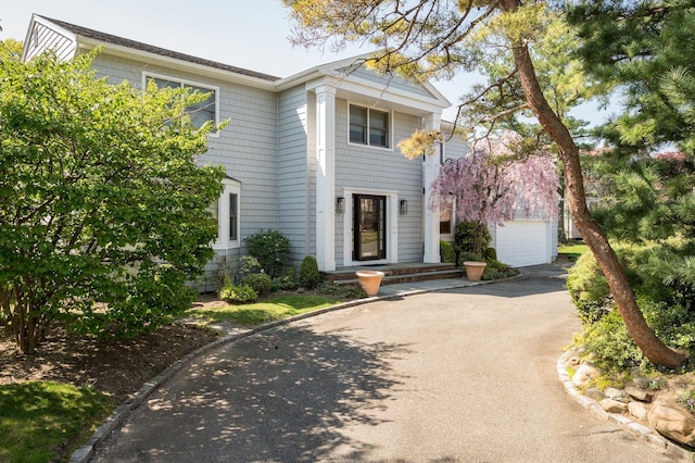 82 Woods Dr, East Hills, NY 11576 - greek revival inspired property featuring asphalt driveway and a garage