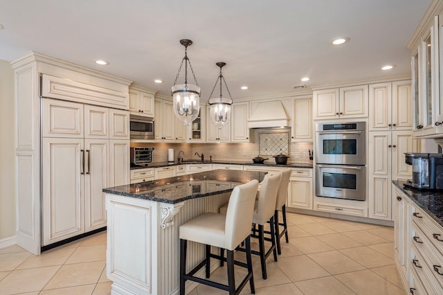 82 Woods Dr, East Hills, NY 11576 - kitchen with stainless steel appliances, custom range hood, light tile patterned floors, backsplash, and recessed lighting