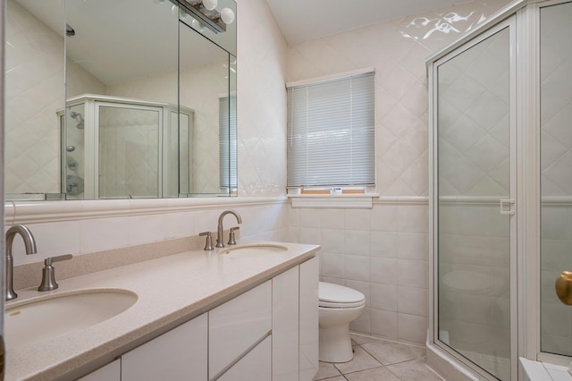 82 Woods Dr, East Hills, NY 11576 - bathroom featuring tile walls, toilet, a shower stall, double vanity, and tile patterned floors