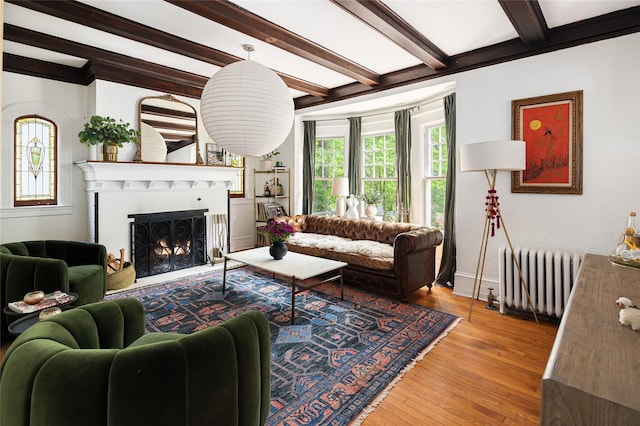 305 Park Hill Ave, Yonkers, NY 10705 - living room with radiator, beam ceiling, healthy amount of natural light, hardwood / wood-style flooring, and a fireplace with flush hearth