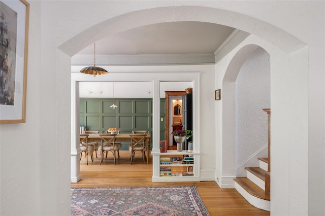 305 Park Hill Ave, Yonkers, NY 10705 - entrance foyer with a textured wall, wood finished floors, crown molding, arched walkways, and stairway