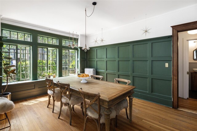305 Park Hill Ave, Yonkers, NY 10705 - dining space featuring a decorative wall, light wood-style flooring, and crown molding