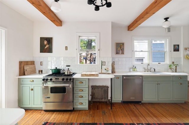 305 Park Hill Ave, Yonkers, NY 10705 - kitchen with green cabinetry, appliances with stainless steel finishes, radiator, beam ceiling, and light wood-type flooring
