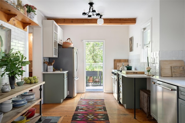 305 Park Hill Ave, Yonkers, NY 10705 - kitchen with stainless steel appliances, light countertops, backsplash, beamed ceiling, and light wood-style flooring
