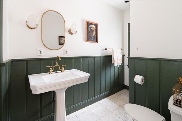 305 Park Hill Ave, Yonkers, NY 10705 - bathroom with wainscoting, tile patterned flooring, and a decorative wall