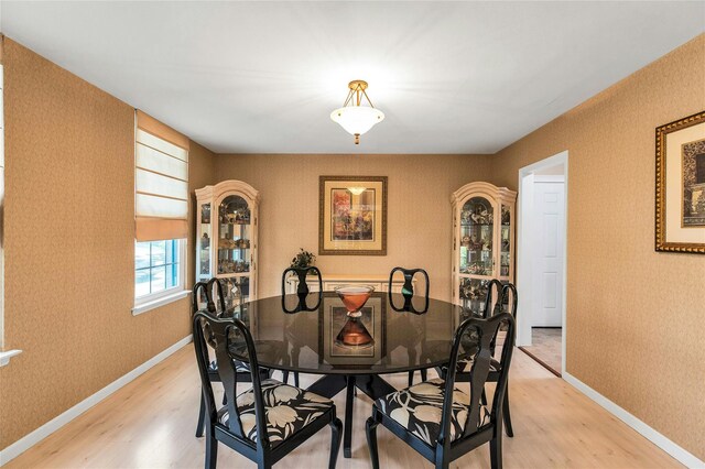 82 Harbour Ln, Bay Shore, NY 11706 - dining space featuring light wood-style floors and wallpapered walls