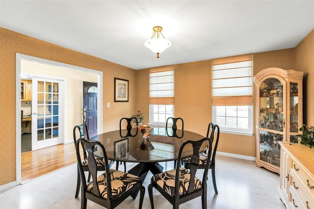82 Harbour Ln, Bay Shore, NY 11706 - dining area with light wood-style floors and wallpapered walls