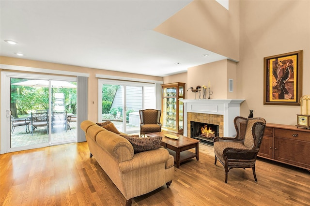 82 Harbour Ln, Bay Shore, NY 11706 - living area featuring light wood-style flooring, a tile fireplace, and recessed lighting