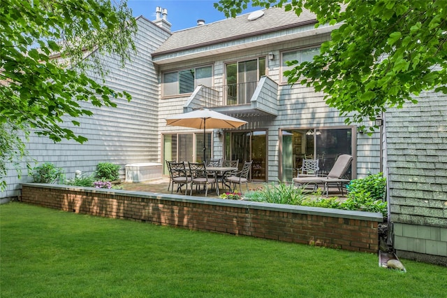 82 Harbour Ln, Bay Shore, NY 11706 - back of house with a balcony, a yard, and a patio area