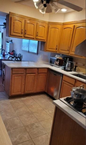10 W 15th Rd, Broad Channel, NY 11693 - kitchen with light countertops, dishwasher, ceiling fan, and brown cabinets