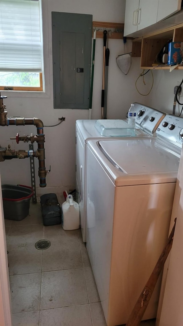 10 W 15th Rd, Broad Channel, NY 11693 - laundry area featuring electric panel, washing machine and clothes dryer, cabinet space, and light tile patterned floors
