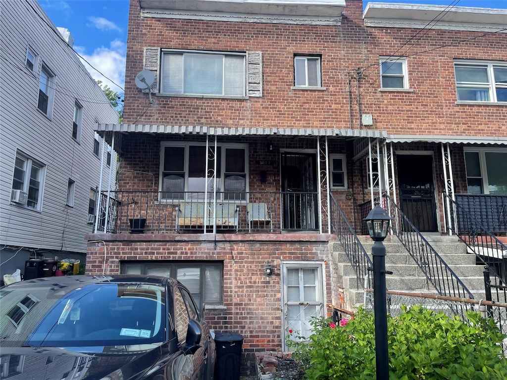 1037 E 214th St, Bronx, NY 10469 - view of front facade featuring brick siding and stairway