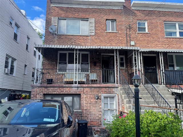 1037 E 214th St, Bronx, NY 10469 - view of front facade featuring brick siding and stairway