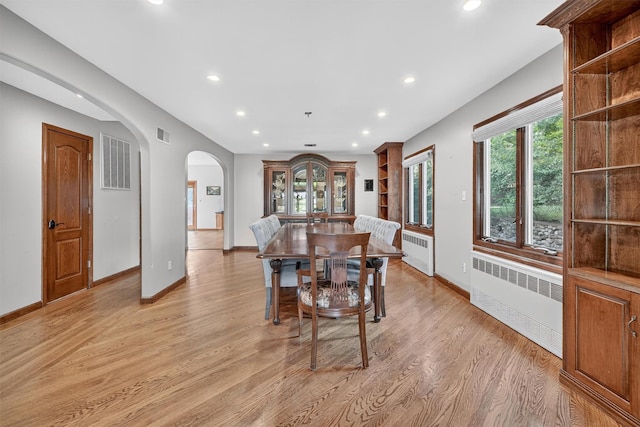 15 Dr Frank Rd, Spring Valley, NY 10977 - dining room featuring radiator, arched walkways, recessed lighting, and light wood finished floors