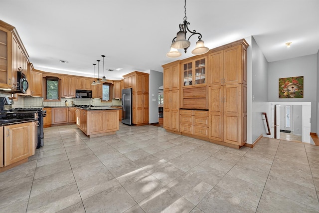 15 Dr Frank Rd, Spring Valley, NY 10977 - kitchen featuring dark countertops, black appliances, decorative backsplash, and a kitchen island