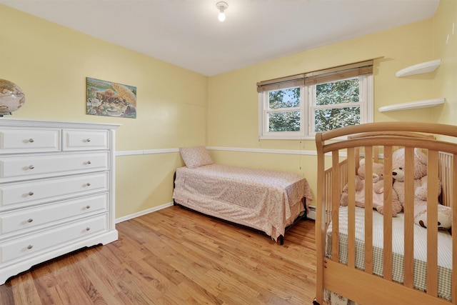 15 Dr Frank Rd, Spring Valley, NY 10977 - bedroom with light wood-style floors and a baseboard heating unit
