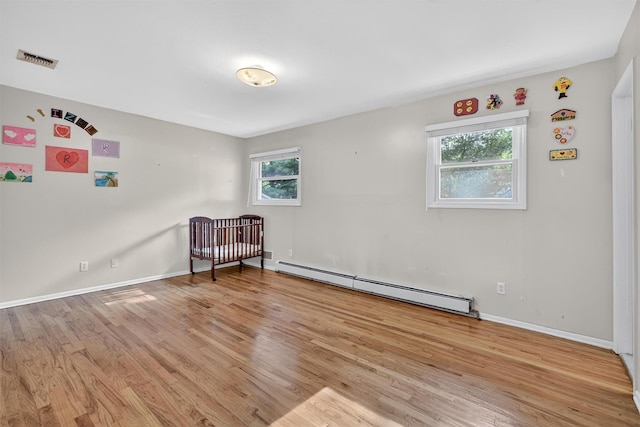 15 Dr Frank Rd, Spring Valley, NY 10977 - empty room with a baseboard radiator and light wood-style floors