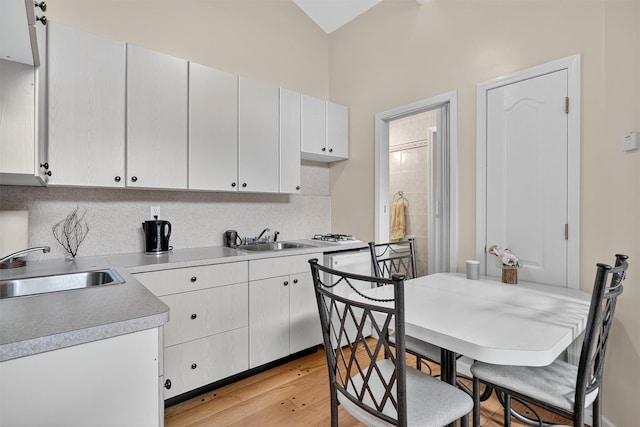 15 Dr Frank Rd, Spring Valley, NY 10977 - kitchen with light wood-style flooring, light countertops, backsplash, lofted ceiling, and dishwashing machine