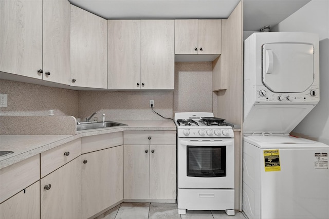 15 Dr Frank Rd, Spring Valley, NY 10977 - kitchen featuring white gas stove, stacked washer / dryer, light countertops, and light brown cabinetry