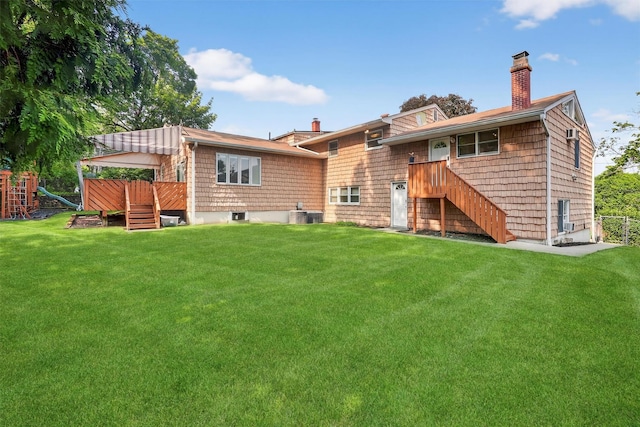 15 Dr Frank Rd, Spring Valley, NY 10977 - back of house featuring a chimney, a yard, stairs, and a playground