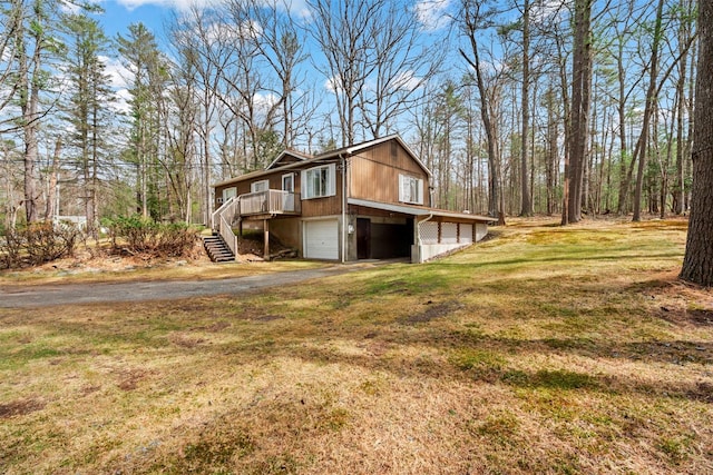 22 Bodine Lake Rd, Call Listing Agent, NY 12792 - view of home's exterior with an attached garage, driveway, stairway, and a yard
