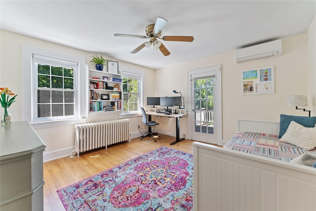 66 Riverview Rd, Irvington, NY 10533 - bedroom featuring radiator, a wall mounted AC, wood finished floors, a desk, and access to exterior