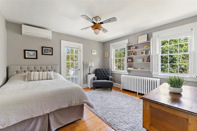 66 Riverview Rd, Irvington, NY 10533 - bedroom featuring radiator heating unit, a wall unit AC, wood finished floors, and ceiling fan