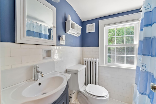 66 Riverview Rd, Irvington, NY 10533 - full bath featuring tile walls, radiator, toilet, vanity, and wainscoting