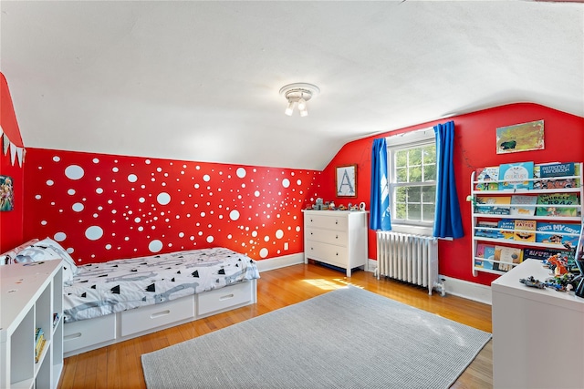 66 Riverview Rd, Irvington, NY 10533 - bedroom with radiator heating unit, lofted ceiling, wallpapered walls, wood finished floors, and baseboards