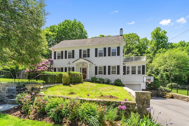 66 Riverview Rd, Irvington, NY 10533 - colonial-style house with a garage, a chimney, stucco siding, and driveway