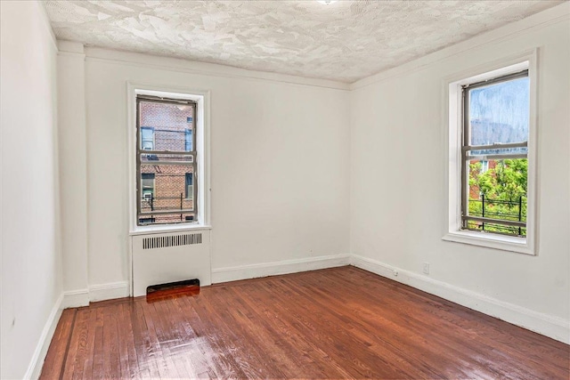 3505 Parsons Blvd Unit 5H, Flushing, NY 11354 - spare room featuring wood finished floors, radiator heating unit, a textured ceiling, and baseboards