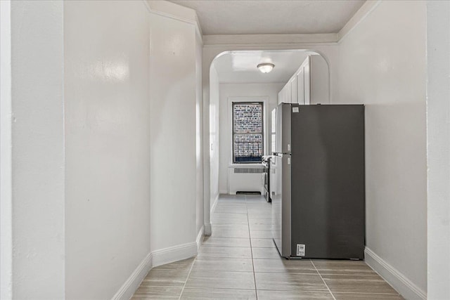 3505 Parsons Blvd Unit 5H, Flushing, NY 11354 - hallway featuring baseboards, arched walkways, and light tile patterned flooring