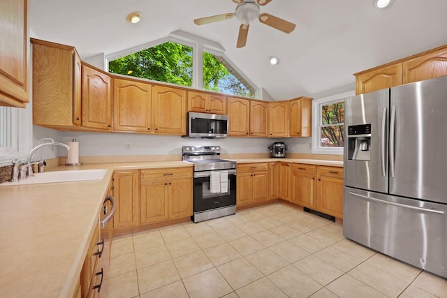 571 Farm To Market Rd, Brewster, NY 10509 - kitchen with stainless steel appliances, a sink, lofted ceiling, light tile patterned floors, and plenty of natural light