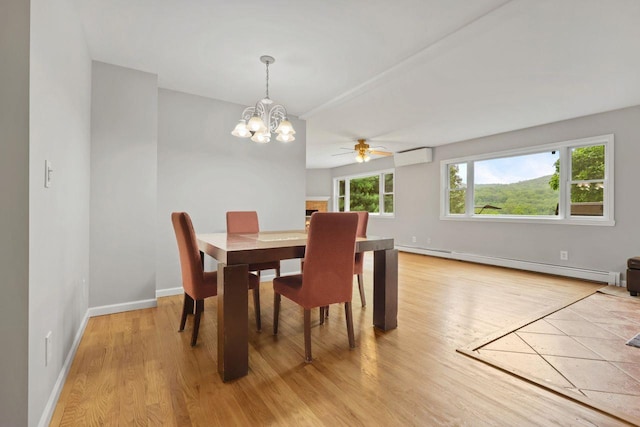 571 Farm To Market Rd, Brewster, NY 10509 - dining area with baseboard heating, light wood finished floors, an AC wall unit, a ceiling fan, and a chandelier
