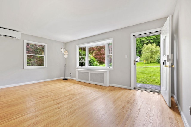 571 Farm To Market Rd, Brewster, NY 10509 - entrance foyer with radiator, a wall mounted AC, healthy amount of natural light, and wood finished floors