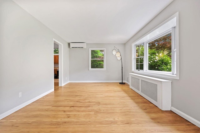 571 Farm To Market Rd, Brewster, NY 10509 - spare room featuring a wall unit AC, baseboards, light wood-style floors, and radiator